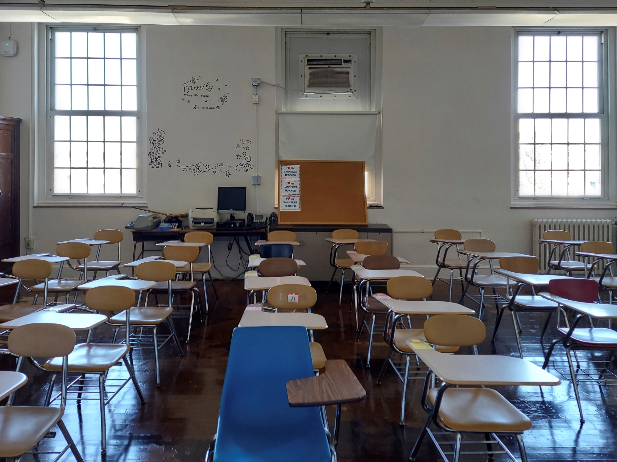 A classroom with muted colors and limited windows 