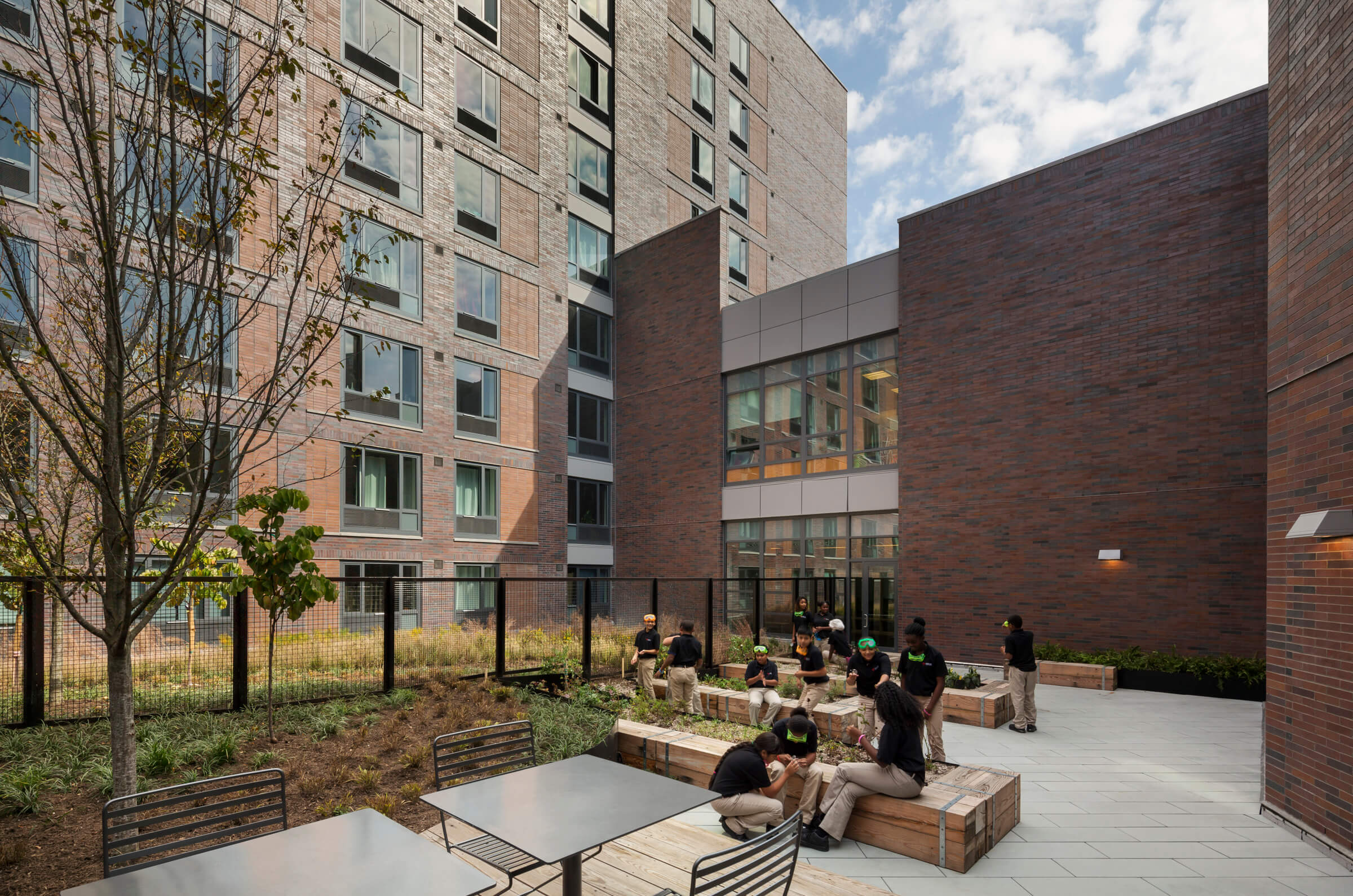 Students sitting in the rooftop garden of the DREAM Charter School