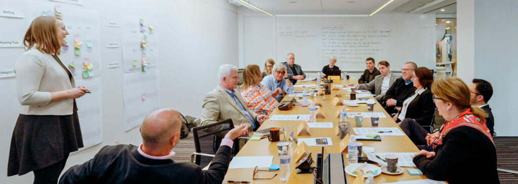 10 CEOs sitting at a table in a think tank